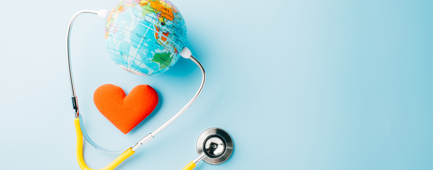 A stethoscope encircling a globe and a red heart on a light blue background.