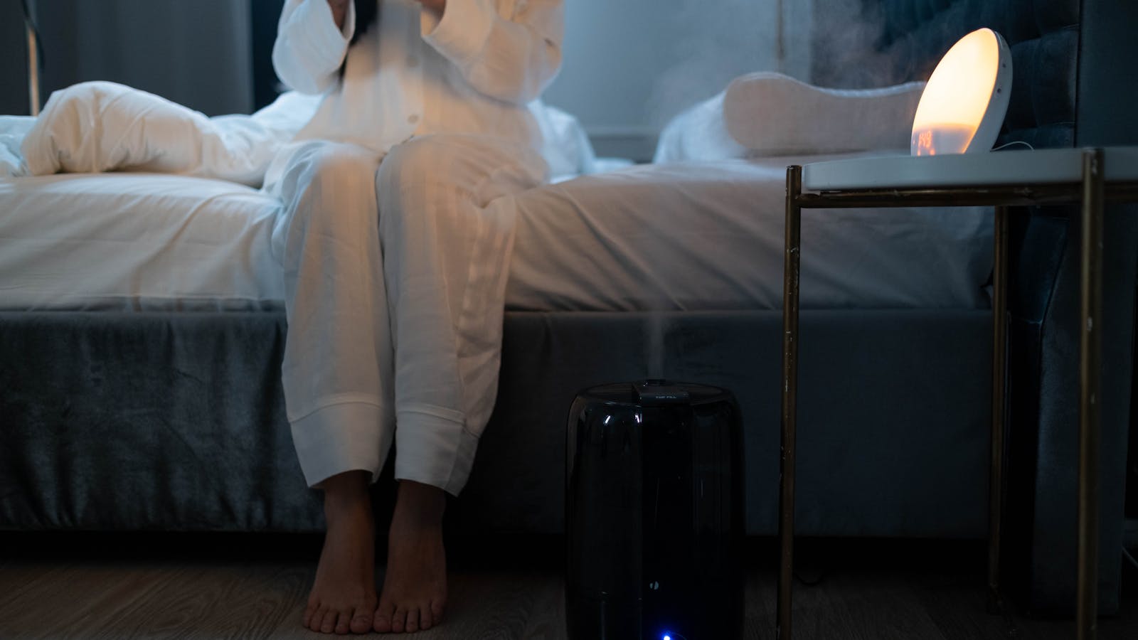 Humidifier mist rising in a calm bedroom.